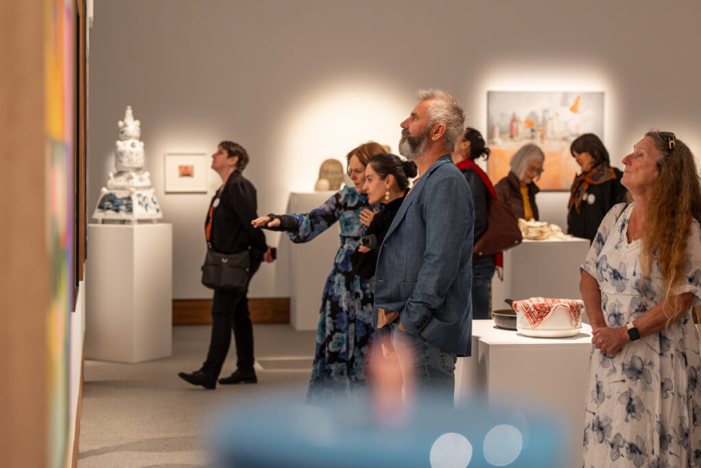 STILL 2023 Award Opening guests looking at artworks in the gallery.